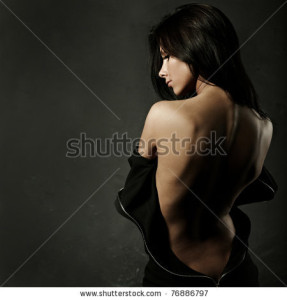 stock-photo-beautiful-woman-in-sexy-evening-dress-against-dark-background-76886797